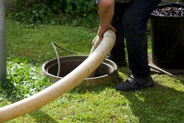 Septic professional pumping out a septic system