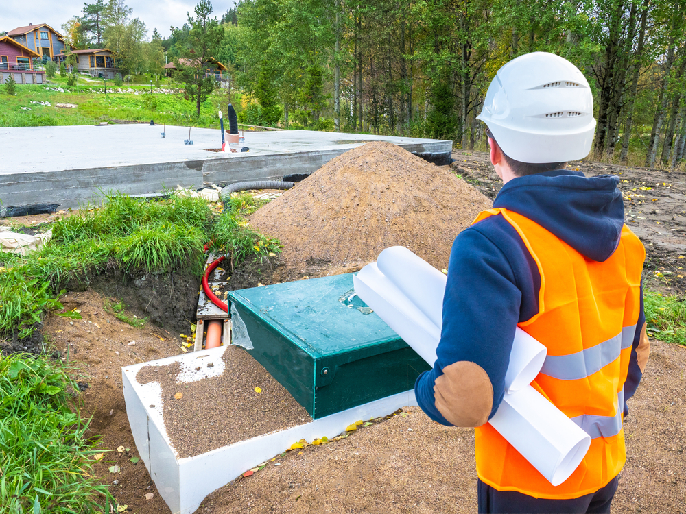 image of septic professional from behind in hi-vis vest and hardhat