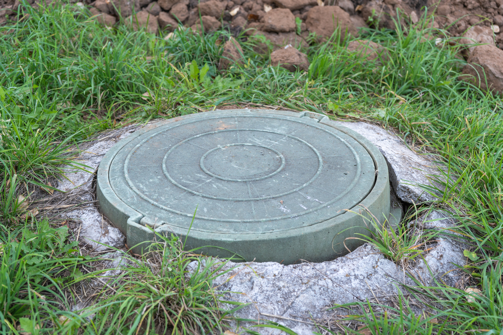 Green plastic manhole cover of the septic tank
