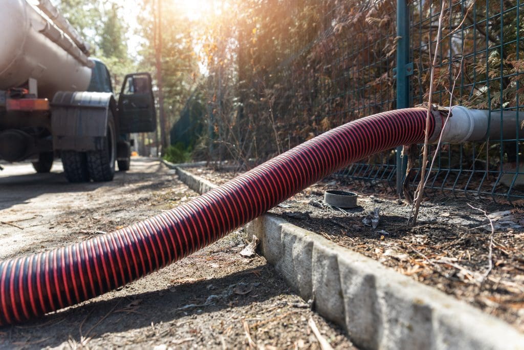 A hose leads to a septic tank to pump out the sludge.