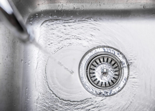 Water flowing down the hole in a kitchen sink