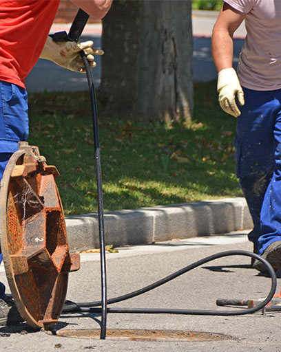 workers draining sewage