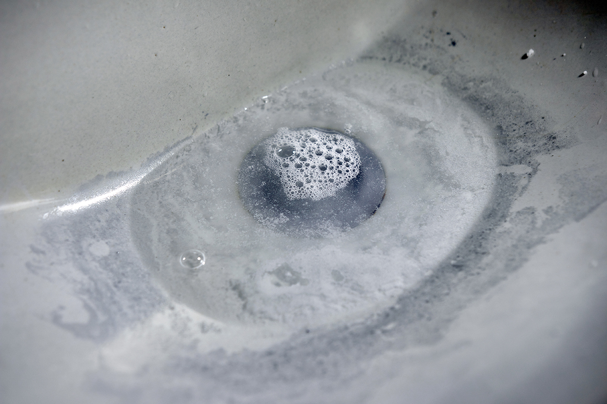 A sink that has a clog and is slow to drain.