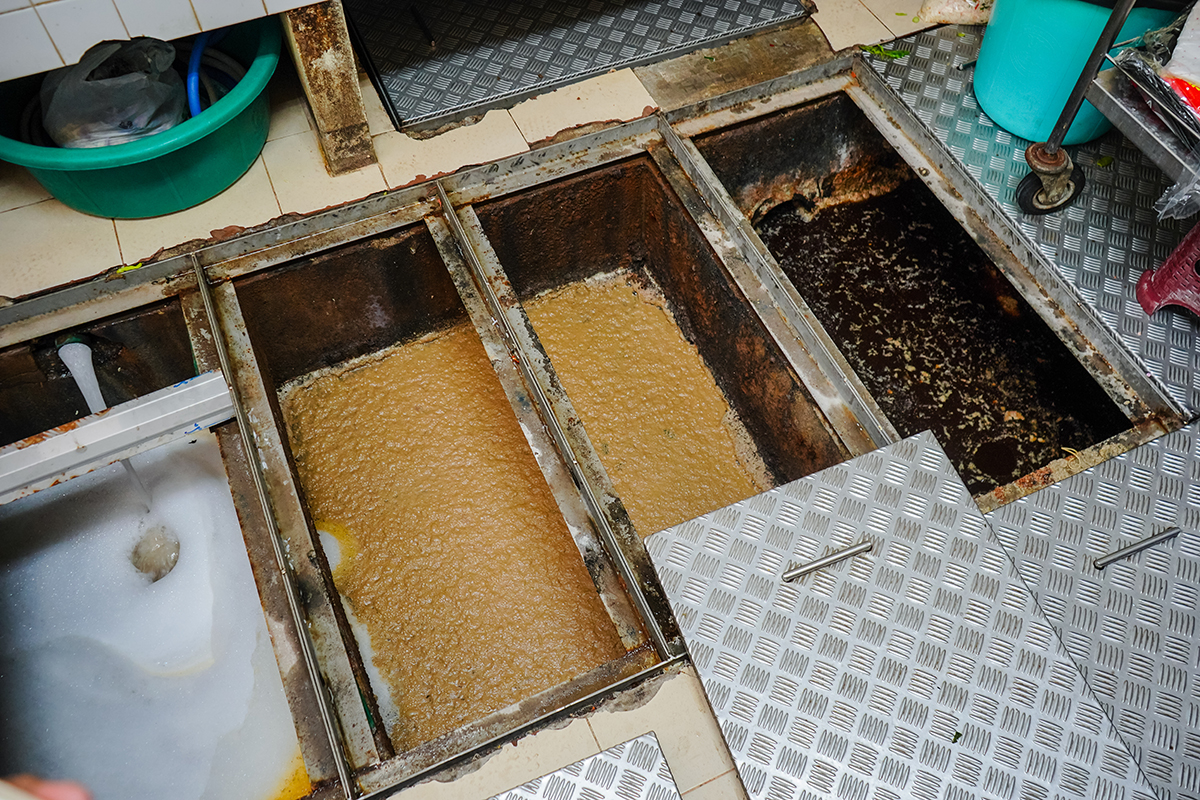 An overview look of a restaurants filled grease trap.