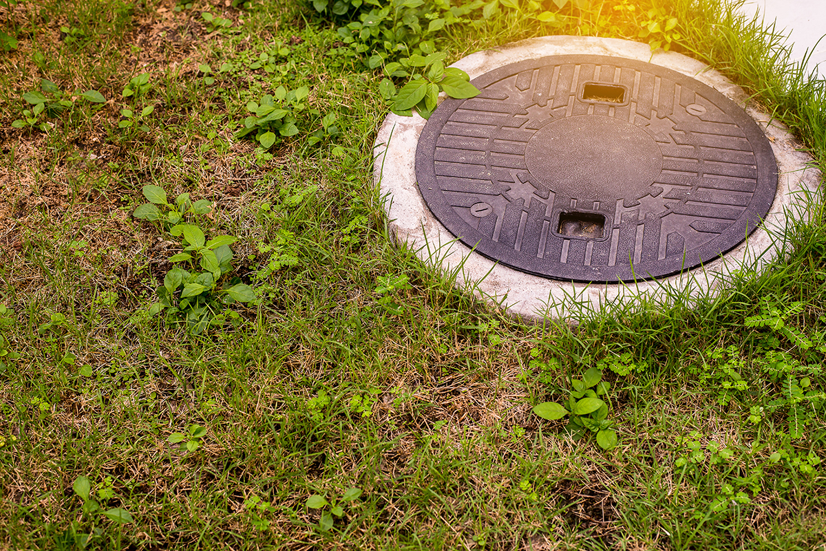 An image of a septic system cover in a yard.