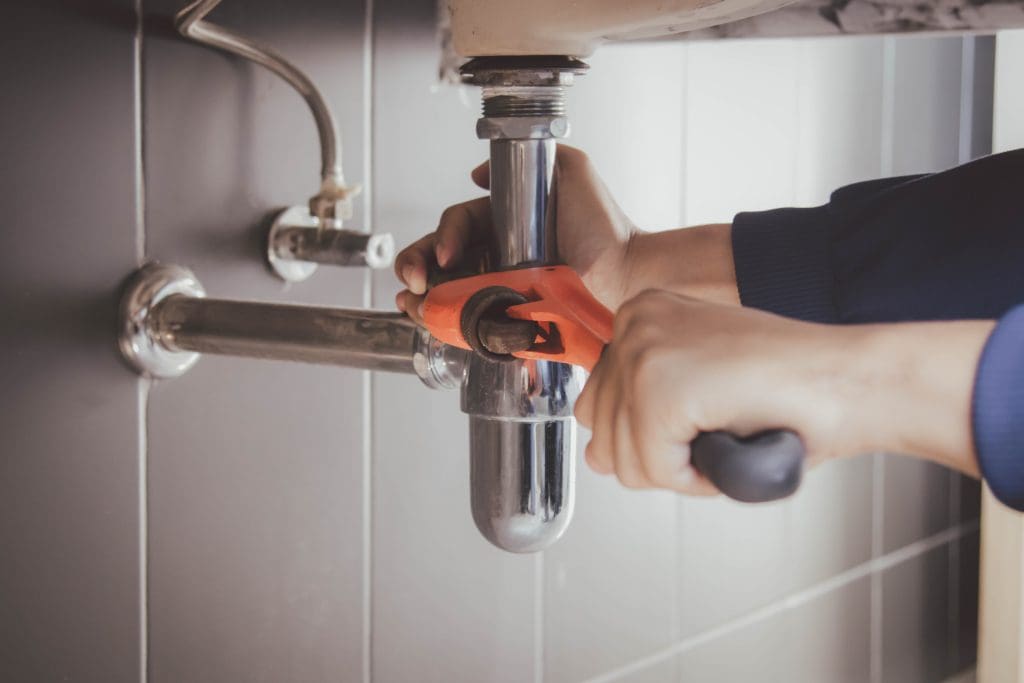 a plumber working on pipes