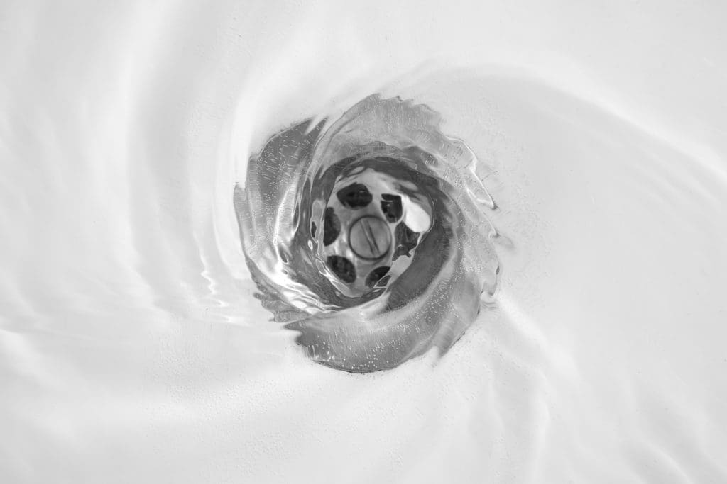 A drain with water washing down quickly