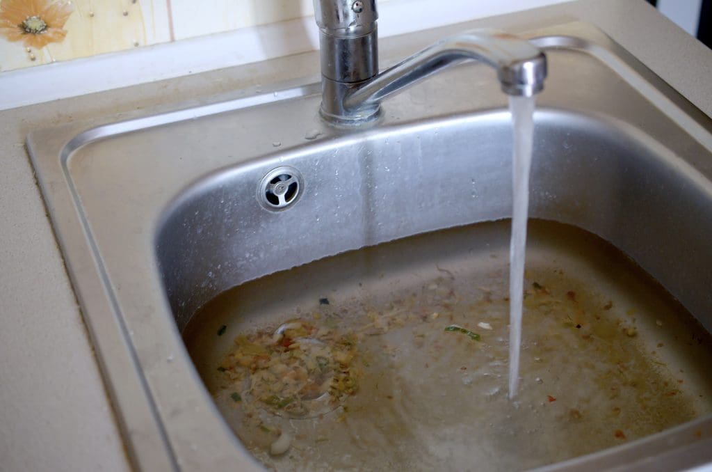 A clogged sink full of food
