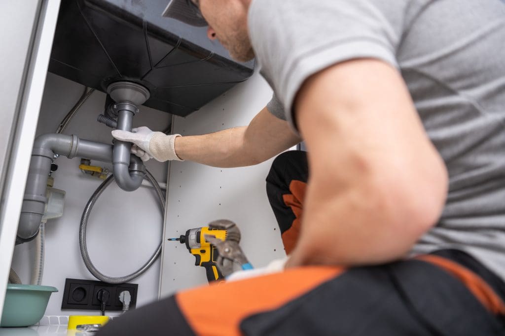 a person repairing a sink