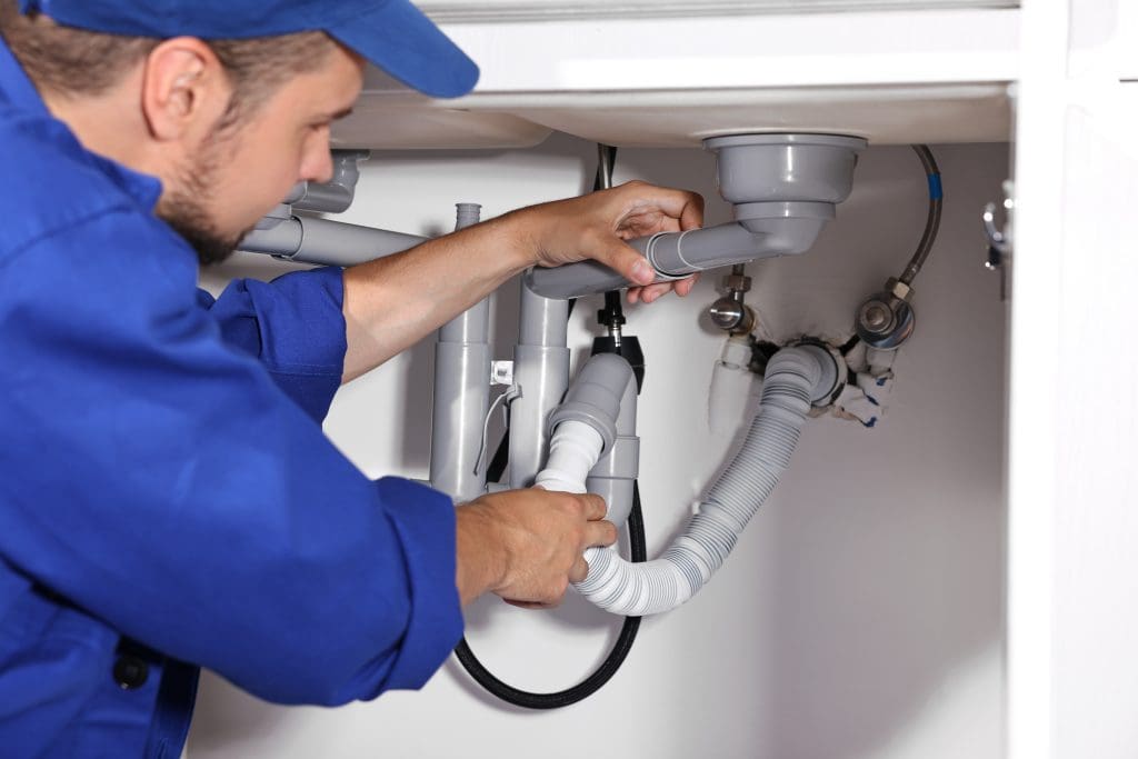 a plumber working on a drain