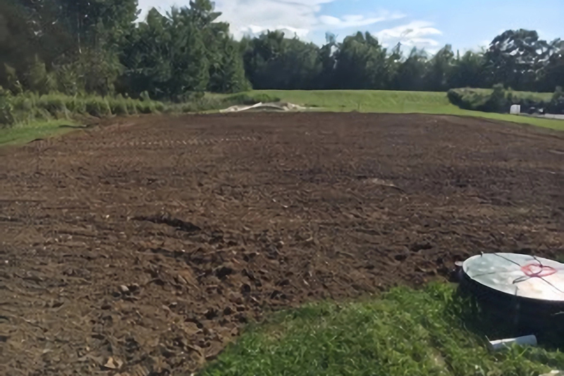 a field with the septic access visible