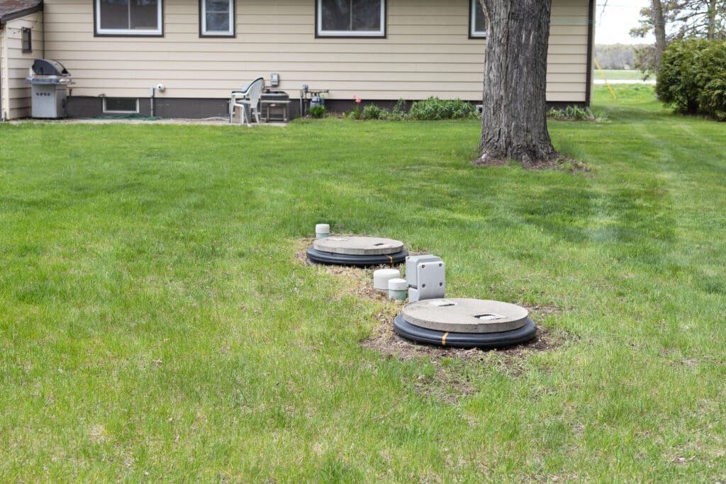 A yard with the septic access visible.