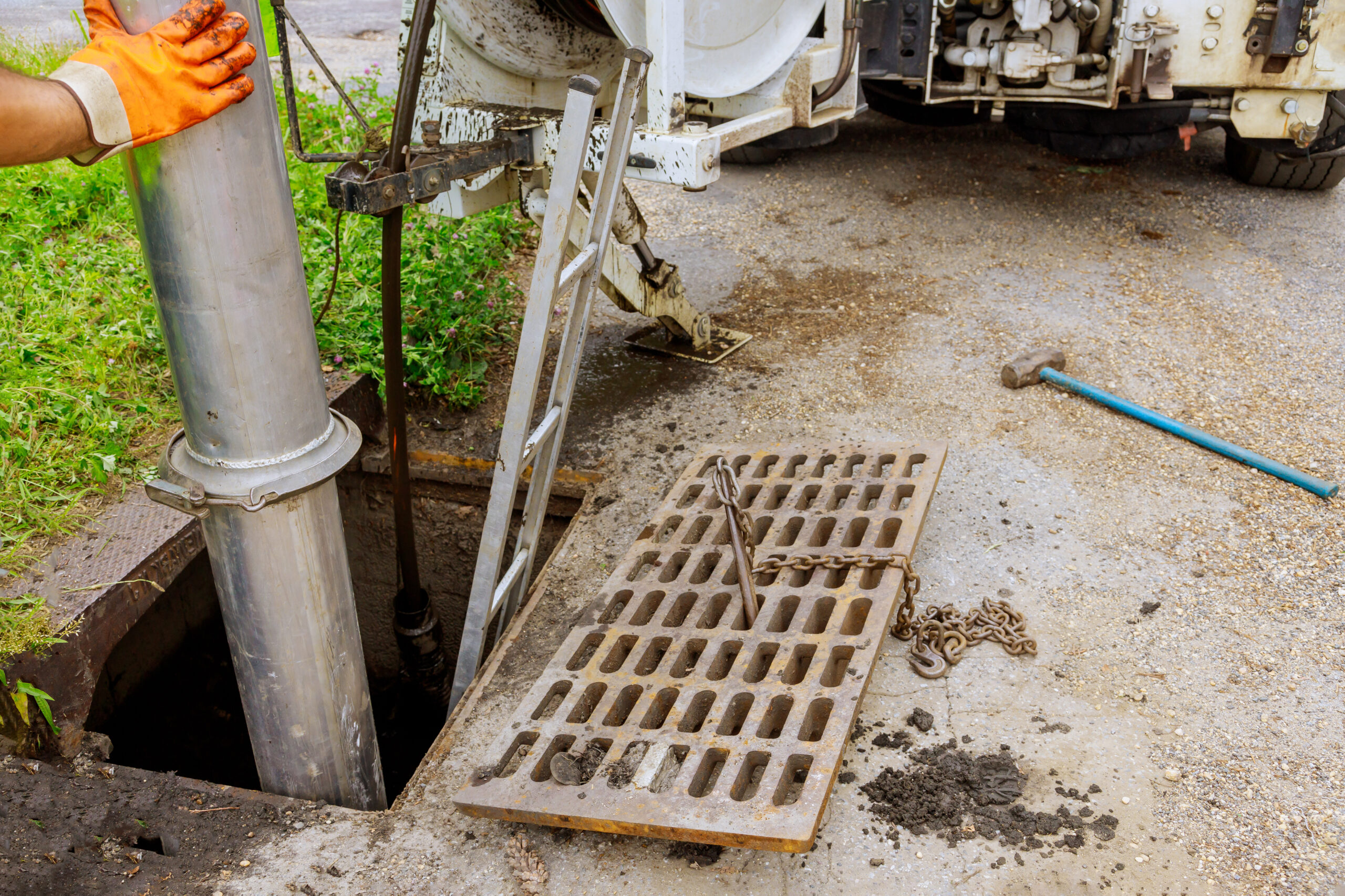 A septic worker working on a sewer line.